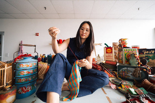 Artist Amanda Phingbodhipakkiya sewing in her studio