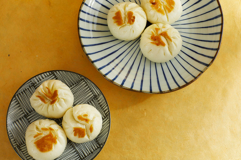 Two plates with fried baozi