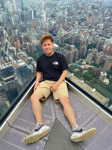 Brandon Leung of Baisun Candles against cityscape of NYC