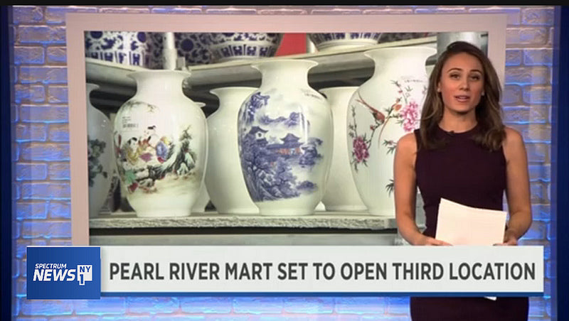 Reporter in front of screen of vases