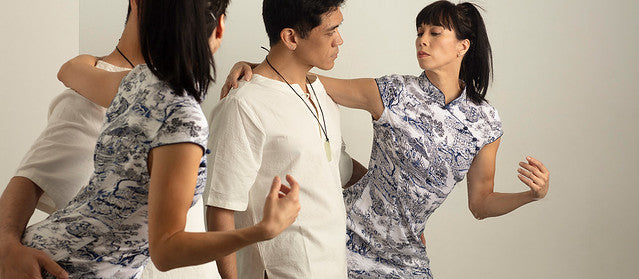 A man and woman in mid-dance in front of a mirror