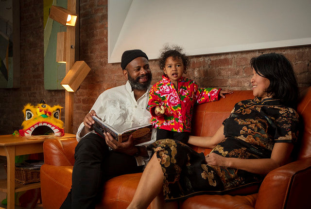 Woman, man, and little girl in Chinese-style clothing