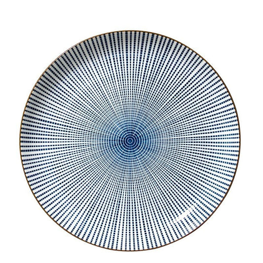 A round ceramic plate featuring a blue and white radial dotted pattern that converges toward the center, with a thin brown rim, shown against a plain white background.