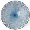 A round ceramic plate with a blue and white radial striped pattern and a brown rim, shown from a top-down view on a white background.