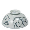 A white ceramic bowl upside down, featuring cute, simplistic illustrations of fluffy dog faces around its exterior. The tone is playful and light.