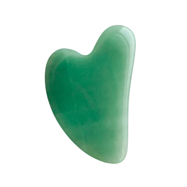 Green gua sha tool on a white background