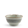 A ceramic bowl with a scalloped rim, featuring a light green glazed interior, a textured gray-blue band around the middle, and a rustic brown edge.