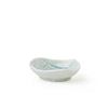 A small handmade ceramic dish with a light blue and white glaze, photographed on a seamless white background.