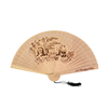 Bamboo fan with engraved design on a white background