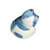 Ceramic cat figurine with blue and white pattern on a white background.