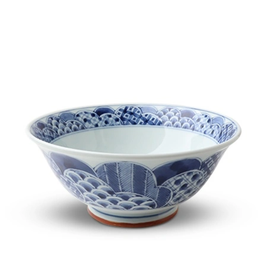 Blue and white ceramic bowl with intricate patterns on a white background
