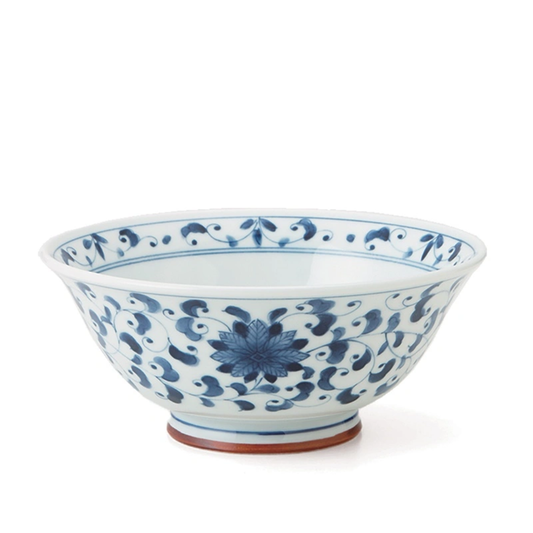 Blue and white ceramic bowl with floral patterns on a white background