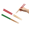 Set of colorful chopsticks with a hand holding red chopsticks on a white background