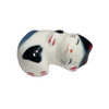 Ceramic cat-shaped object with blue, white, and black colors on a white background.