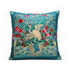 Decorative pillow with embroidered design of a crane and flowers on a blue background