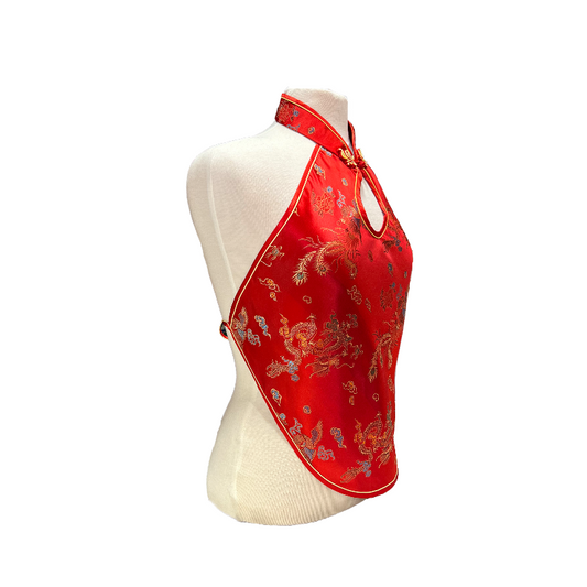 Red halter top with floral patterns on a mannequin against a white background