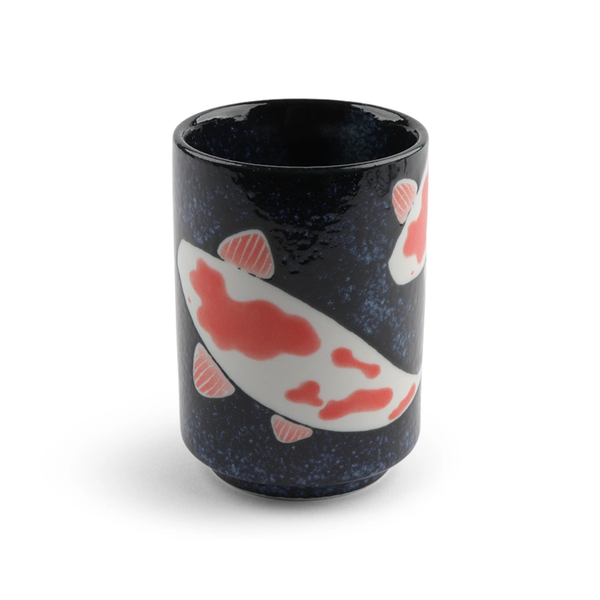 A black ceramic cup features colorful koi fish with red and white patterns, creating a serene, artistic design. The background has a subtle speckled texture.