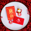 Red and gold cards with Pearl River Mart logo on a white plate against a red textured background