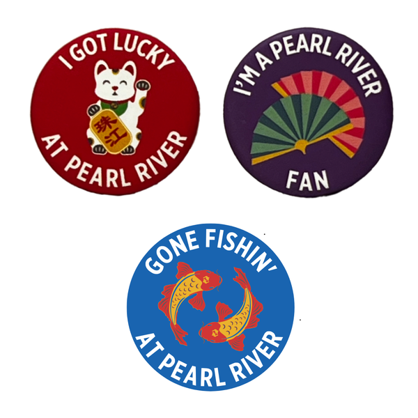 Three Pearl River Mart themed pins in red, purple, and blue with designs and wording on white background