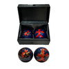 Four decorative balls with dragon-phoenix patterns in a black box on a white background