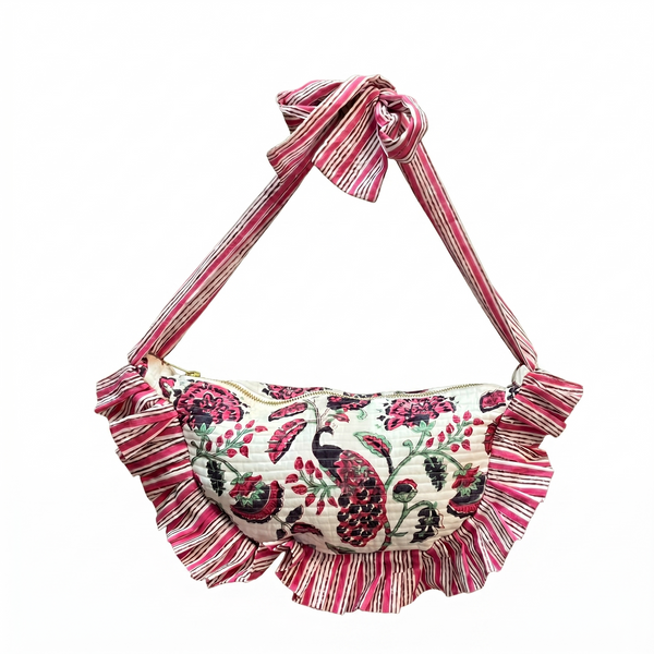 Pink and white purse with floral and peacock design on white background