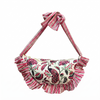 Pink and white purse with floral and peacock design on white background
