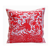 Decorative pillow with red and white crane design on a white background