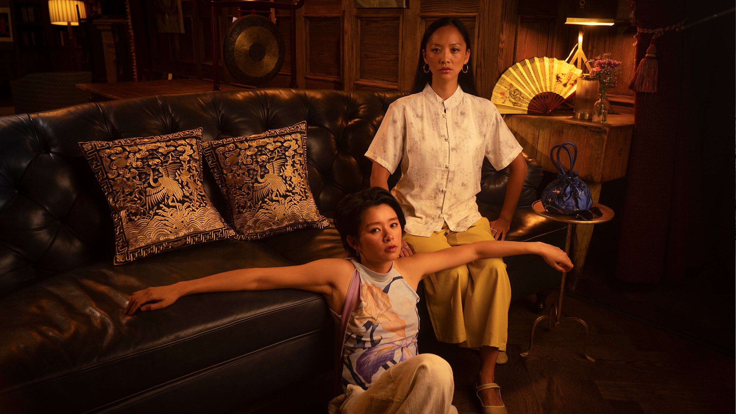 Two women in fashionable clothing in a sumptuous living room