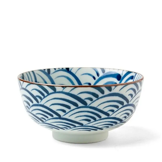 A ceramic bowl featuring a blue wave pattern on a white background. The rim is outlined in copper, adding an elegant, traditional touch.