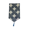 Decorative table runner with geometric pattern and tassel on a white background