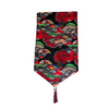 Decorative table runner with fan and floral pattern on a black background