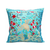 Decorative pillow with embroidered crane and floral patterns on a blue background