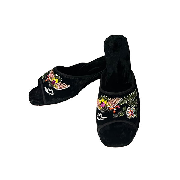 A pair of black velvet peep-toe slippers decorated with colorful floral and bird embroidery on the sides, shown against a plain white background.