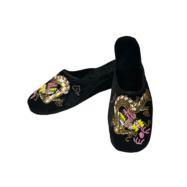 A pair of black slip-on traditional Chinese embroidered shoes featuring detailed dragon and floral beadwork in gold, pink, and yellow on a plain white background.