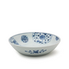 White ceramic bowl with blue floral patterns on a white background