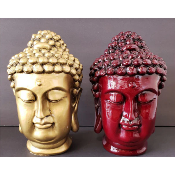 Two Buddha head statues made of resin. One painted in mahogany, the other bronze.