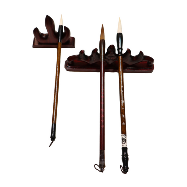 Three calligraphy brushes on two brush stands