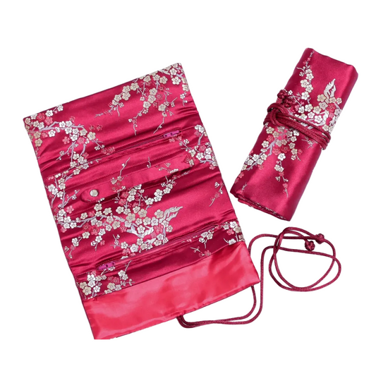 Red brocade jewelry roll with white blossoms