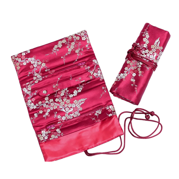 Red brocade jewelry roll with white blossoms