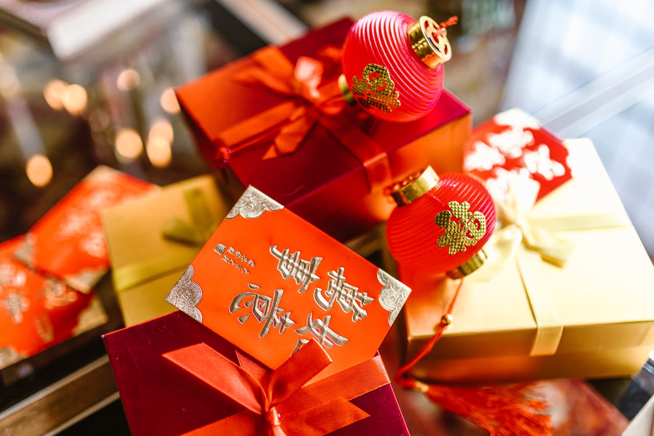 Decorative red gift box with gold ribbons and Chinese characters, blurred background