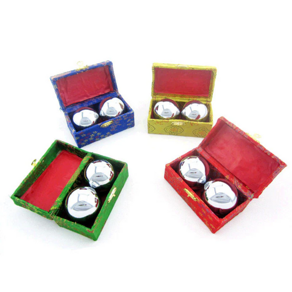 Green, Blue, Yellow, and red boxes each holding a pair of chrome metal therapy balls