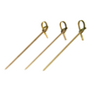 Three gold skewers with decorative ends on a white background
