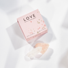 Pink 'LOVE' stone pack with clear quartz on a white background