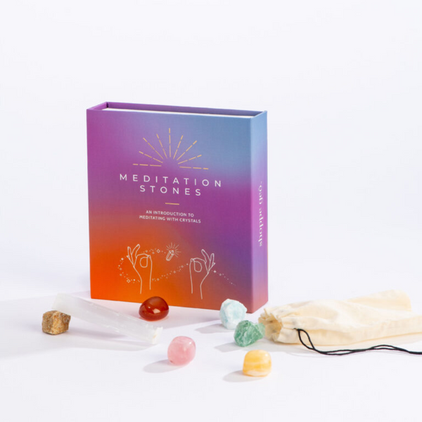 Colorful box of Meditation Stones with colorful stones and small drawstring bag in front of the box