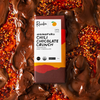 Momofuku chili chocolate crunch bar on background of melted chocolate and chili crunch