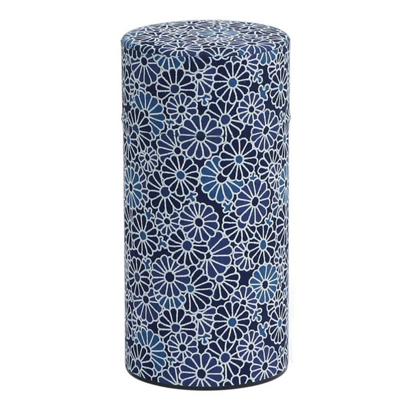Cylindrical canister with blue floral pattern on a white background
