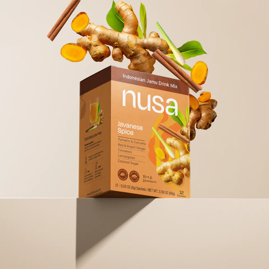 Nusa Javanese Spice drink mix box with ginger root and cinnamon sticks on a beige background