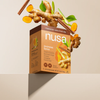 Nusa Javanese Spice drink mix box with ginger root and cinnamon sticks on a beige background