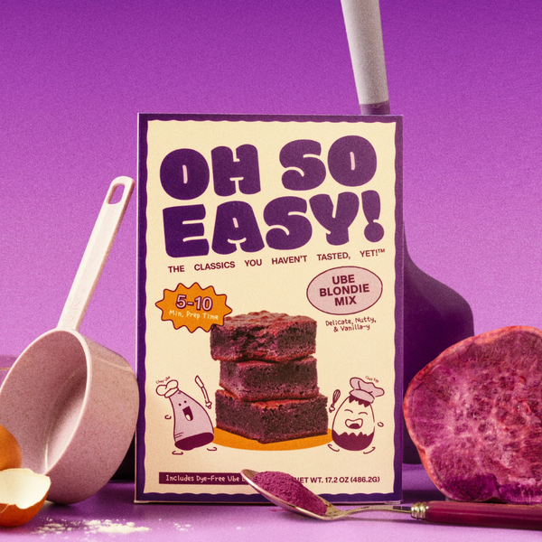 Ube blondie mix packaging with baking tools on a purple background