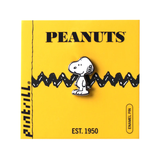 Peanuts enamel pin on a yellow background with Snoopy.